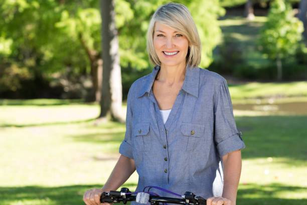 Woman with bicycle in park