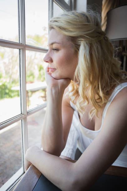istock Pretty blonde sitting by the window 690288100