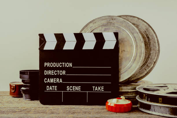 istock Clapperboard, tin boxes with film and lens 690291052