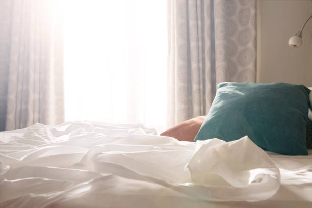 Morning sunshine on the bed White Bed and Red and green pillows with wrinkle blanket in bedroom morning after pill stock pictures, royalty-free photos & images