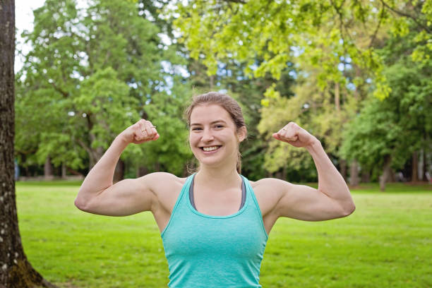 istock Happy Young Woman shows off Muscles 690293772