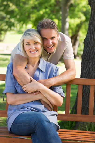 istock Loving man embracing woman in park 690302766