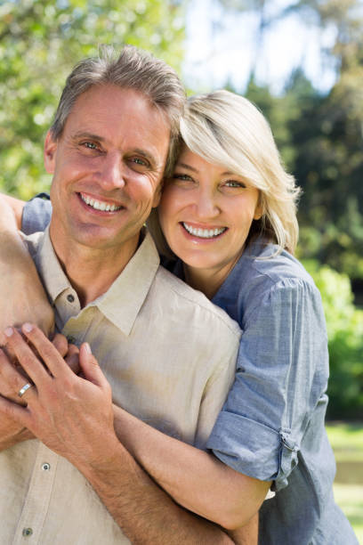 istock Couple embracing in park 690302924