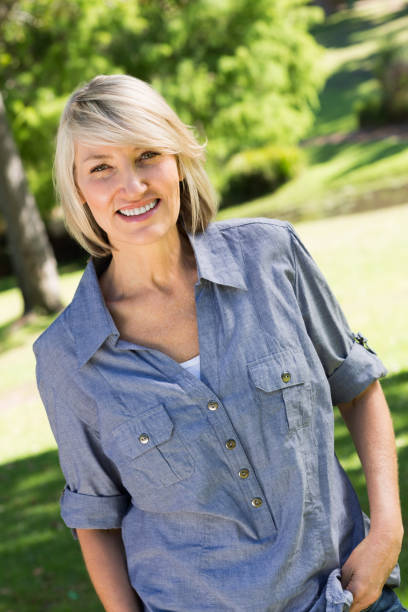 istock Beautiful woman smiling in park 690302934