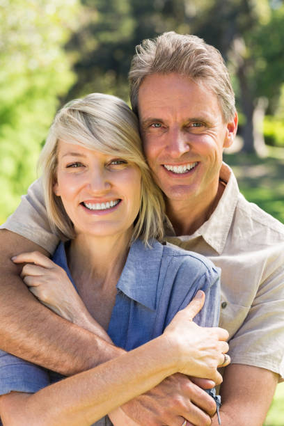 istock Couple embracing in park 690303022