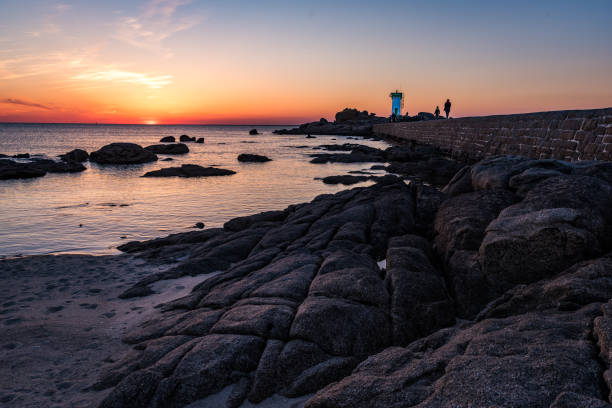 istock Rocky coast and lighthouse in Trevignonat sunset, Brittany 690303096