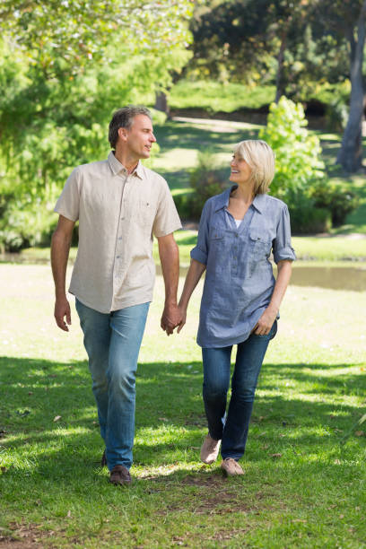 istock Romantic couple walking in park 690303510