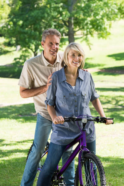 istock Couple riding bicycle in park 690313838