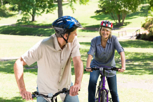 istock Couple cycling in park 690314082