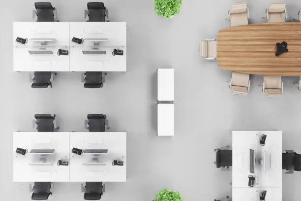 Office desks, chairs and meeting table in a modern office meeting room viewing from top.