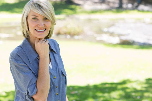 istock Beautiful woman smiling in park 690314500