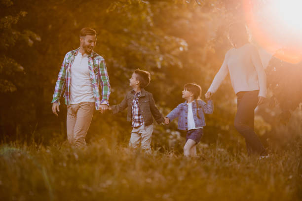 istock Young happy family taking a walk in the park and communicating. 690314612
