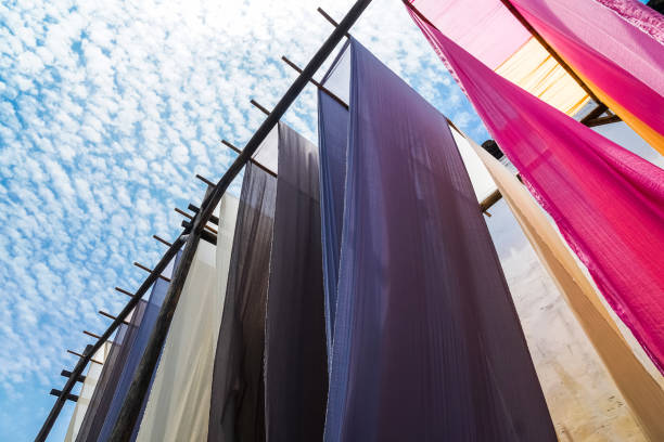 istock colorful fabric hanging to dry after traditional dye process 690314768