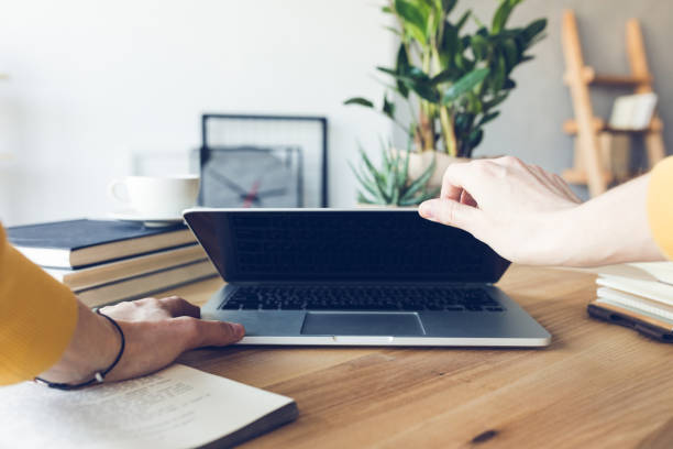 istock human hands holding laptop at workplace in home office 690315878
