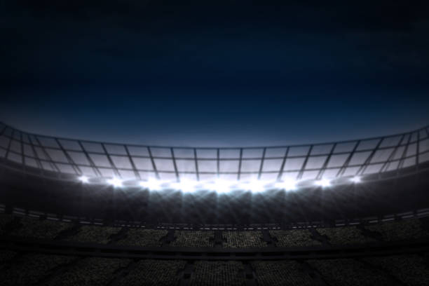 istock Large football stadium under night sky 690318412