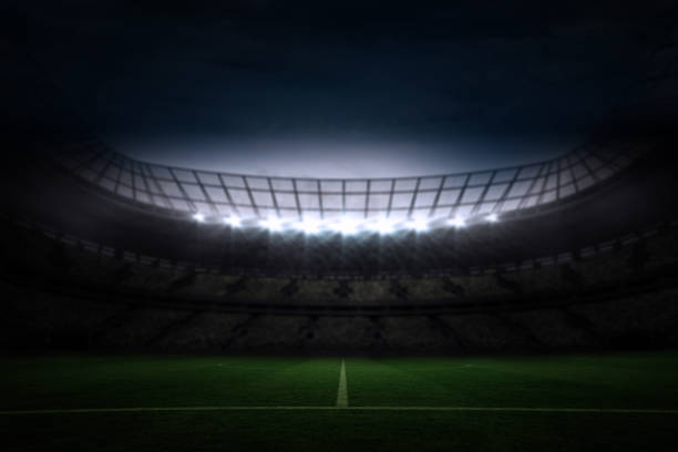 istock Large football stadium under night sky 690318422