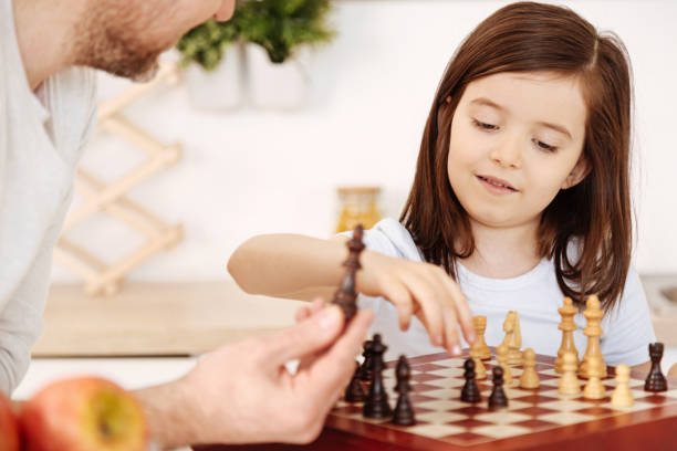 istock Pretty little girl setting up a chessboard 690318566