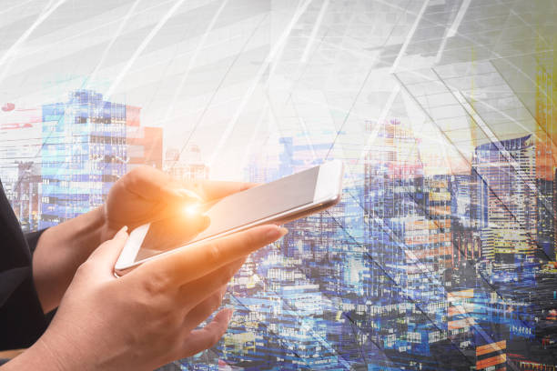 istock Businessman holding smart phone with wireless communication network icon and cityscape background. E-commerce smart connection business. internet of things. 690319004
