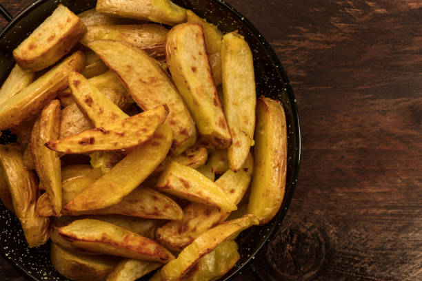 istock Crunchy roasted potatoes in skillet on dark rustic texture 690319634