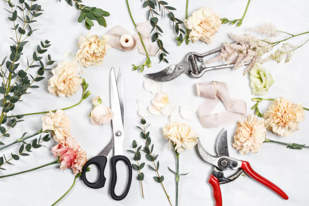 istock The florist desktop with working tools on white wooden background 690326096