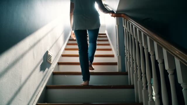 Barefoot Woman Going Up a Staircase