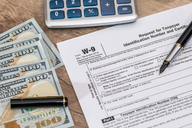 istock tax form - w9 - with dollar and pen. 690330374