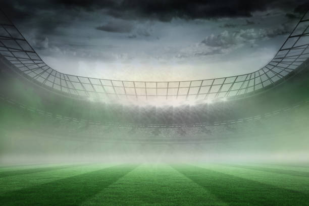istock Misty football stadium under spotlights 690332852