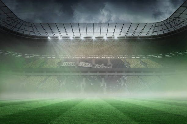 istock Misty football stadium under spotlights 690332866