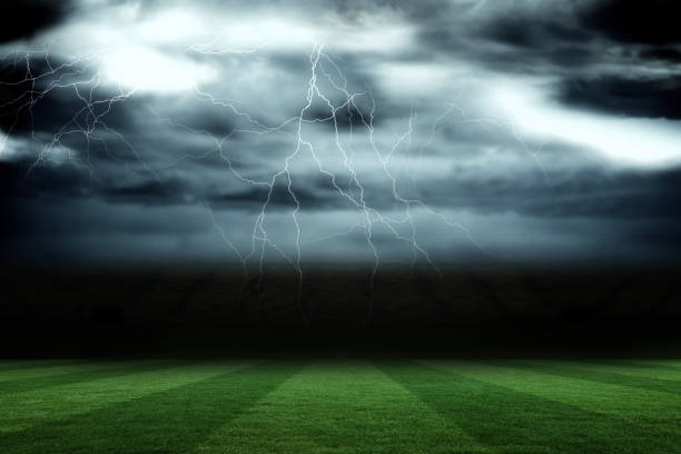 Football pitch under stormy sky stock photo