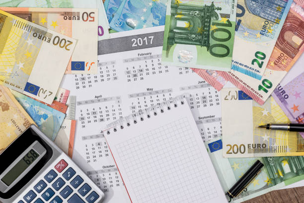 istock different euro bills with 2017 calendar and pen. 690334208