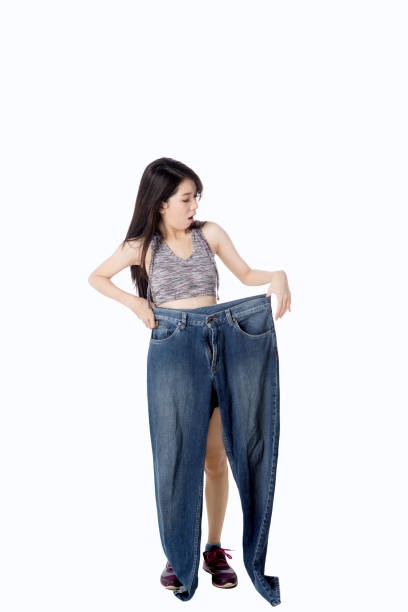 istock Healthy woman holds large jeans 690337280