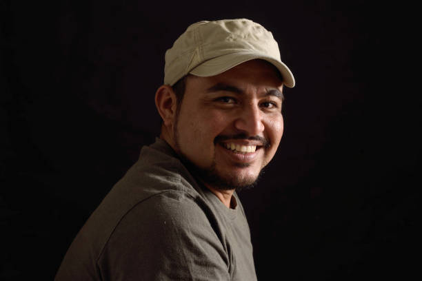 istock Portrait of a latin man on black background 690338732
