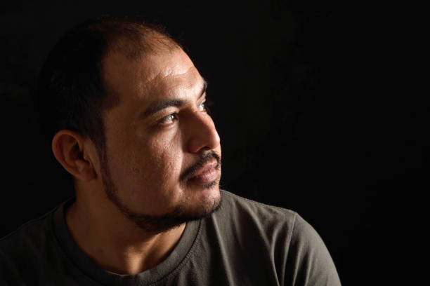 istock Portrait of a latin man on black background 690342748