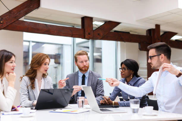 istock Business people cooperating and exchanging ideas during formal meeting 690349996