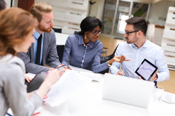 istock Business people analyzing financial chart with a financial analyst 690357222