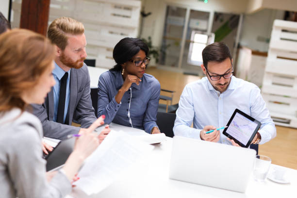 Business people analyzing financial chart with a financial analyst