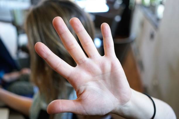 self defense, woman covering her face with hand - violence domestic violence victim women imagens e fotografias de stock