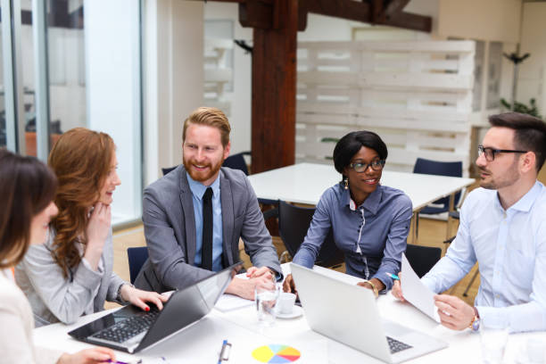 istock Business people cooperating and exchanging ideas during formal meeting 690364102