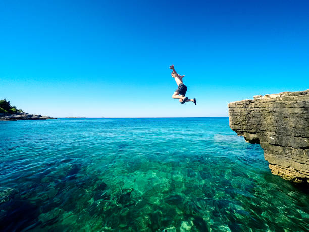 happy boy jumping in the croatian sea stock photo