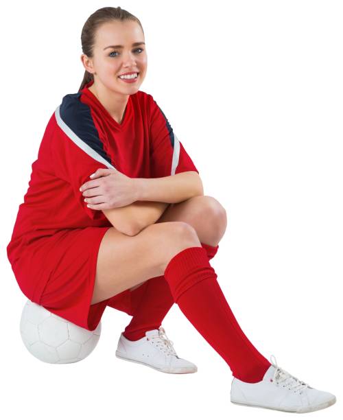 istock Cute football player sitting with ball 690379142