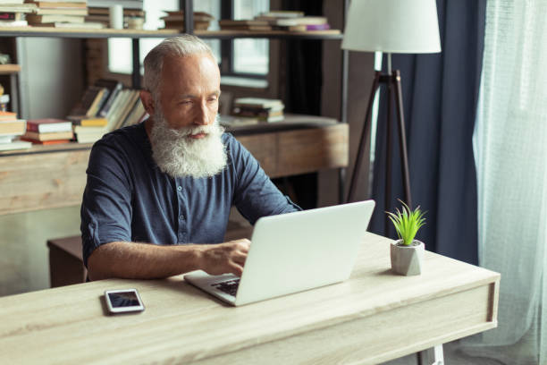 istock concentrated man typing on laptop at home office workplace 690379500