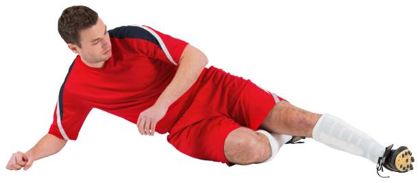 istock Football player in red kicking 690379654