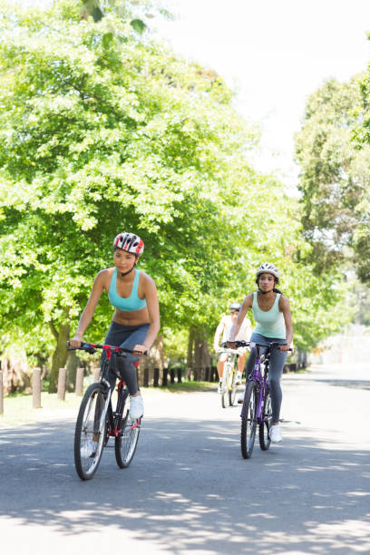 istock Sporty women riding bicycles 690385432