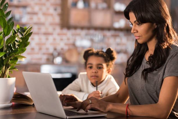 istock side view of mother helping daughter doing homework 690385678