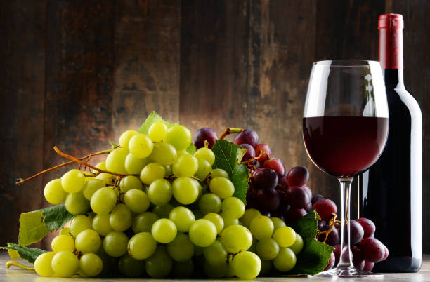 istock Composition with glass, bottle of red wine and fresh grapes 690390510