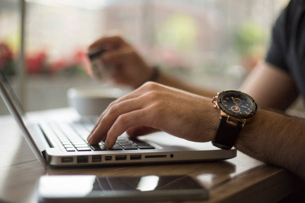 istock Online shopping.Hands holding credit card and using laptop 690393758
