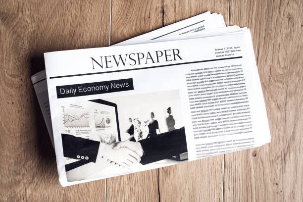 istock Newspaper on wooden table 690393992