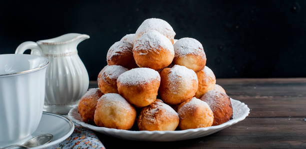 istock donuts laid out pyramid sprinkled with powdered sugar 690397624