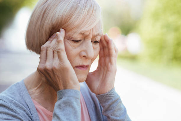 istock Concentrated pensioner suffering from headache on the street 690397744