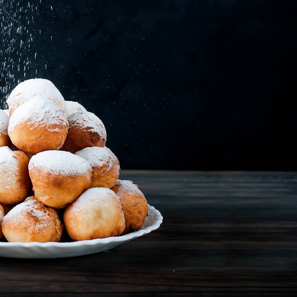 istock donuts laid out pyramid sprinkled with powdered sugar 690397776